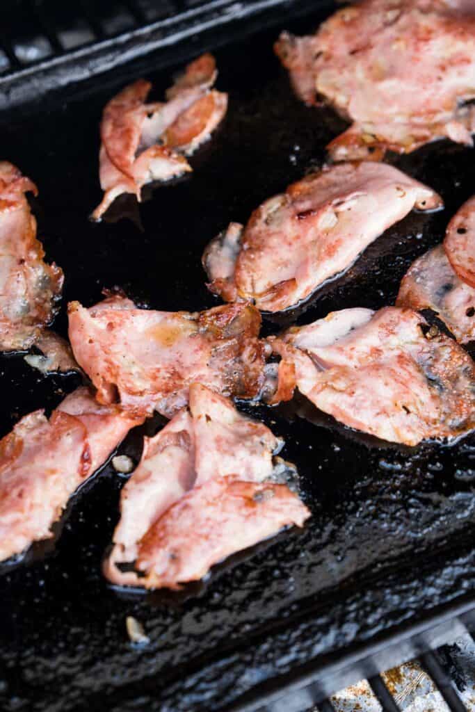 mortadella slices frying on a hot plancha