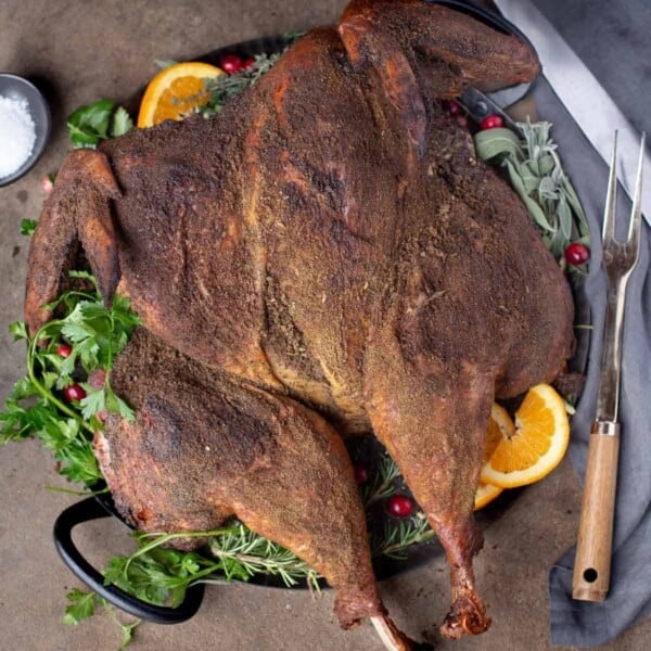 A pellet grilled smoked turkey on a serving platter