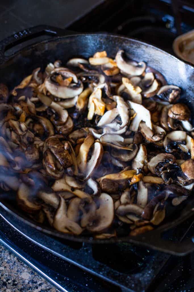 sautéing mushrooms in a cast iron skillet