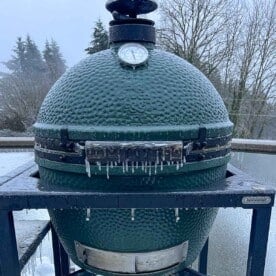 A Big Green Egg frozen with icicles hanging
