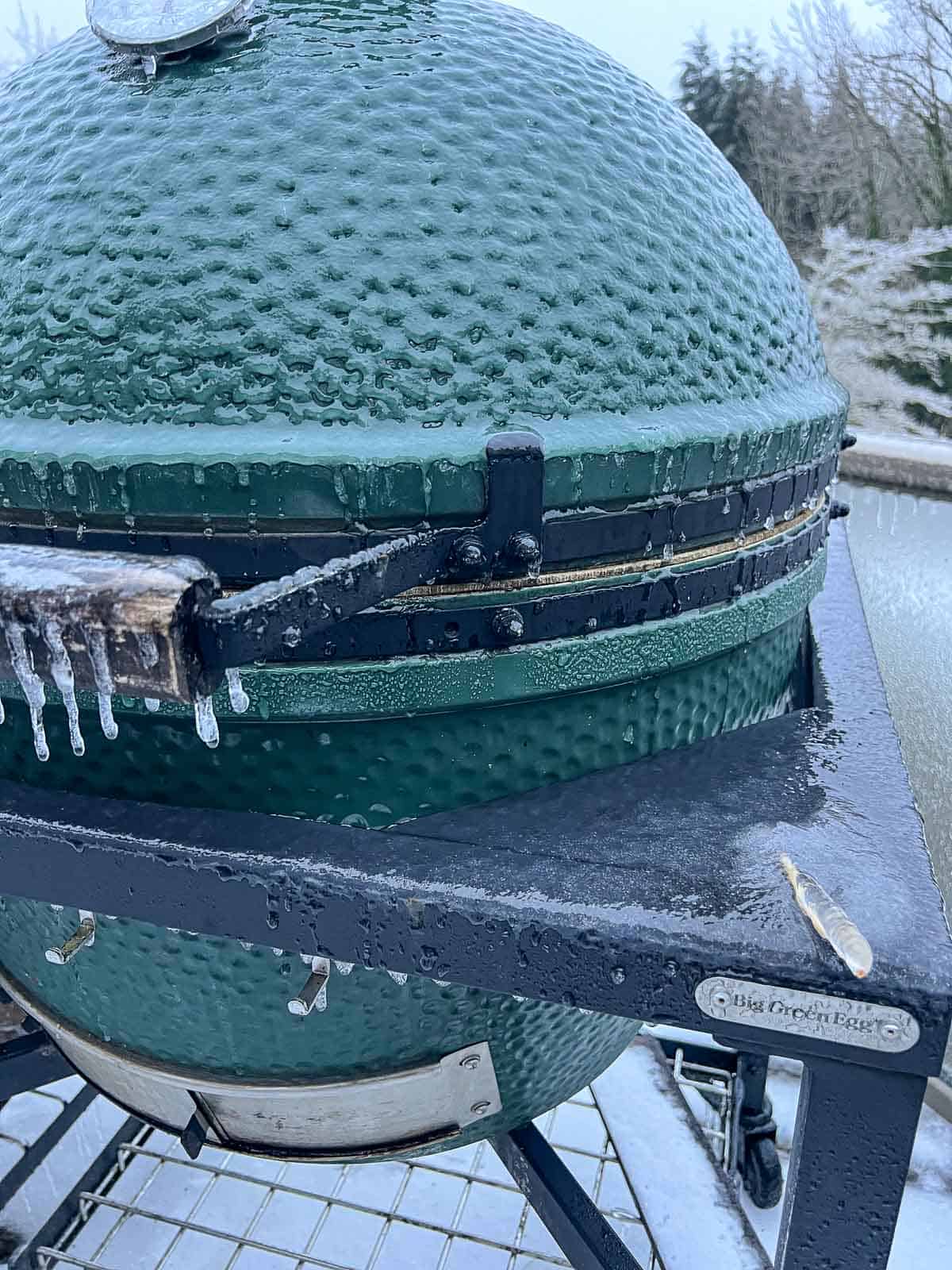 A frozen big green egg starting to warm up.