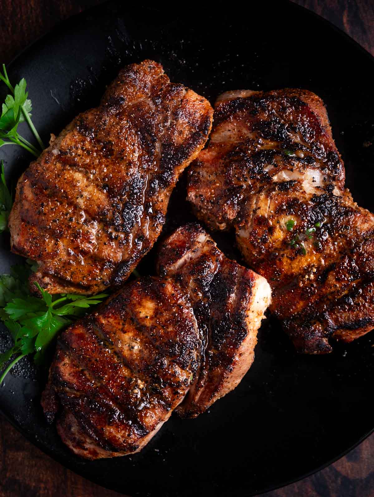 grilled pork chops resting on a plate
