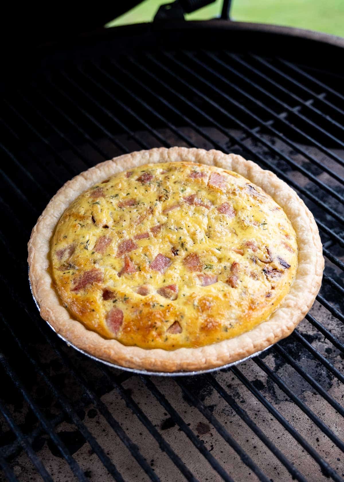 A grilled quiche almost done on a Big Green Egg grill.