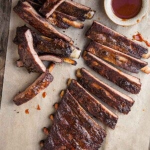 Smoked pork ribs on a platter with bbq sauce