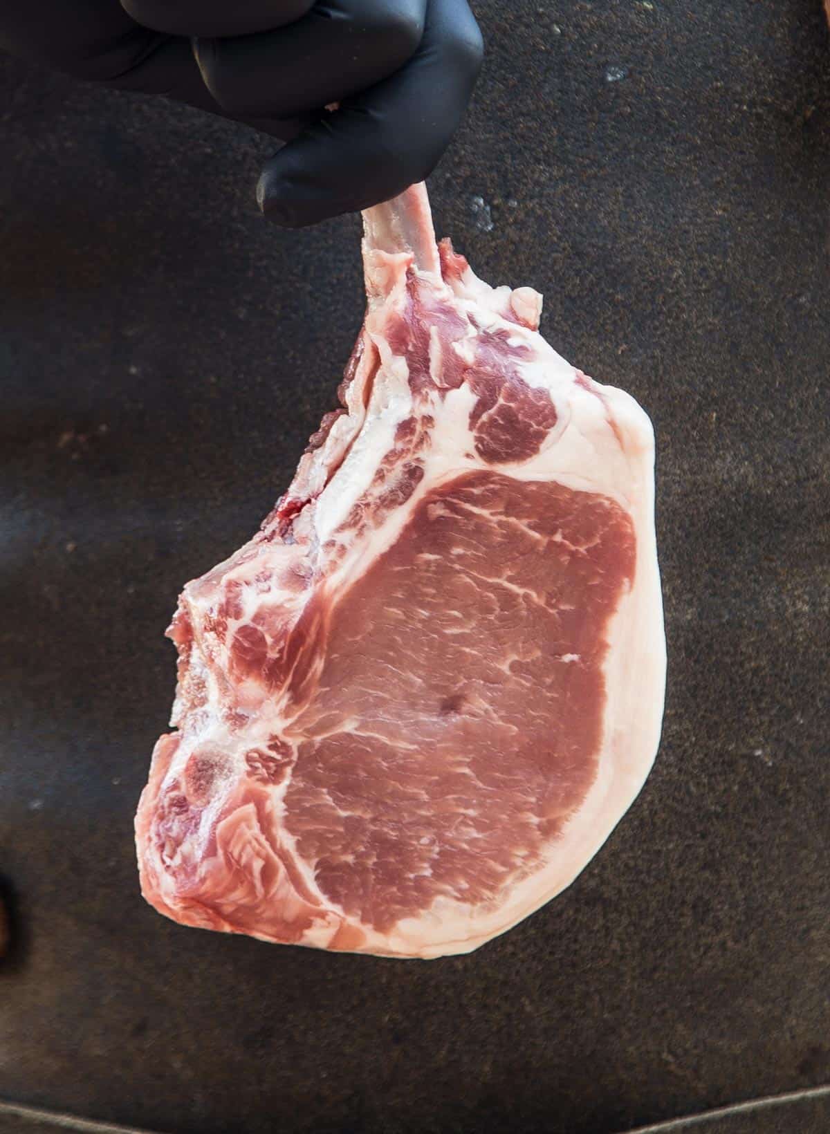 A raw pork t-bone steak