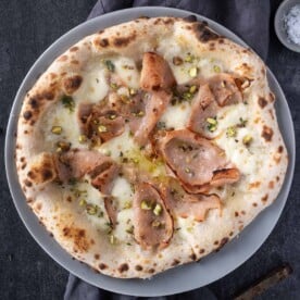 Mortadella pizza on a serving platter