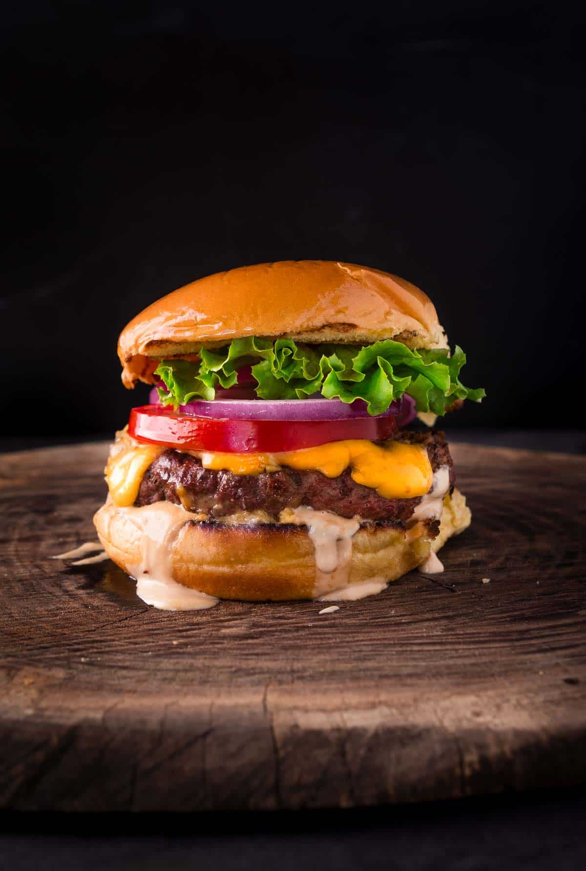 Smoked Hamburger on a cutting board with all the fixings.