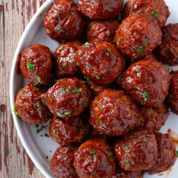 BBQ turkey meatballs on a plate and sauced with a red wine bbq sauce.