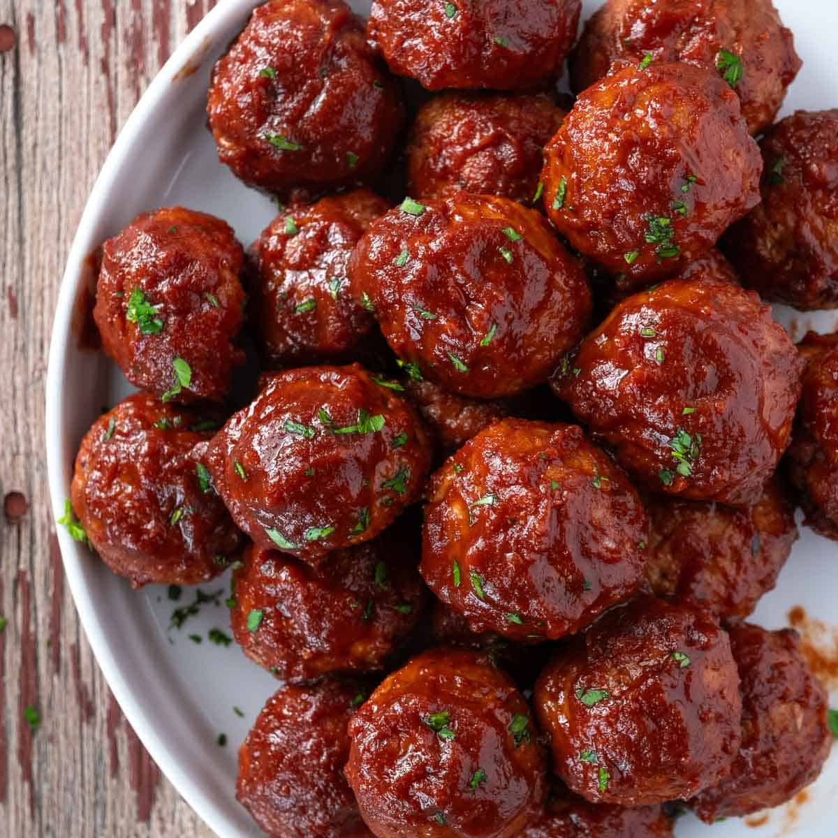 BBQ turkey meatballs on a platter and sauced with a red wine bbq sauce.