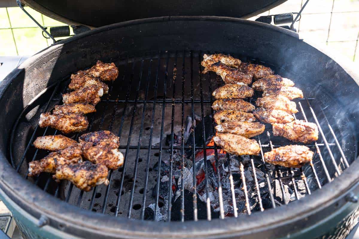Chicken wings on a grill cooking with direct heat and indirect heat