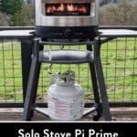 Solo Stove Pi Prime with the flame on high on top of a stand on a deck.
