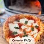 Pinterest pin showing a margherita pizza on a wooden pizza peel coming out of a pizza oven.