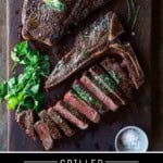 Pinterest Pin showing Two t bone steaks on a cutting board one sliced and topped with an herb compound butter.