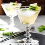 Two cucumber spritz cocktails in cocktail glasses with cucumber garnish.