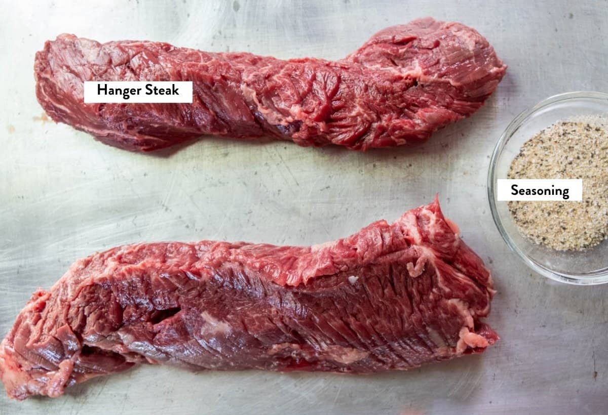 Ingredients for grilled hanger steak on a baking sheet.