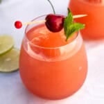 A rosé wine slushie in a stemless wine glass