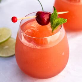 A rosé wine slushie in a stemless wine glass