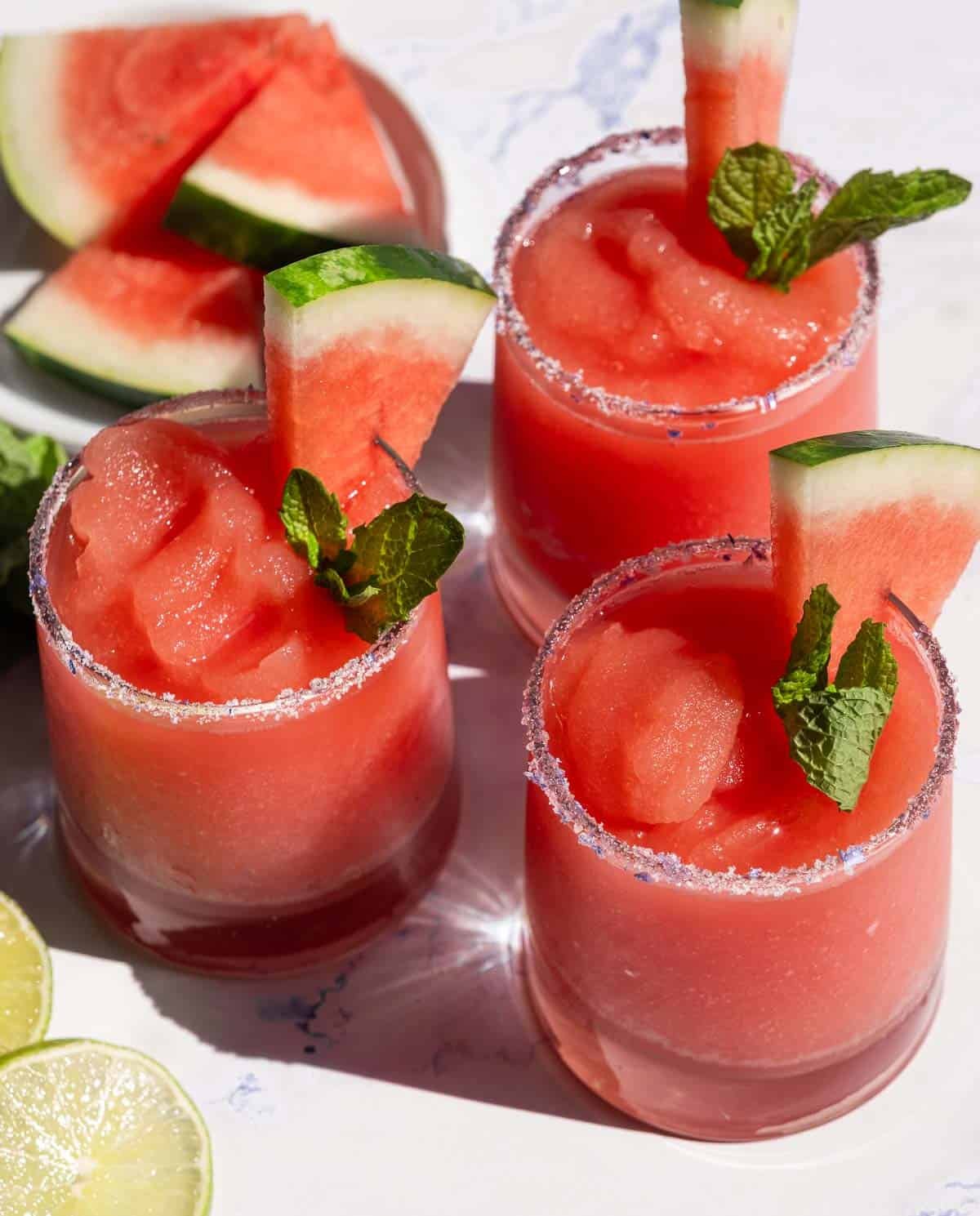 Three glasses filled with Watermelon Frosé Slushies.