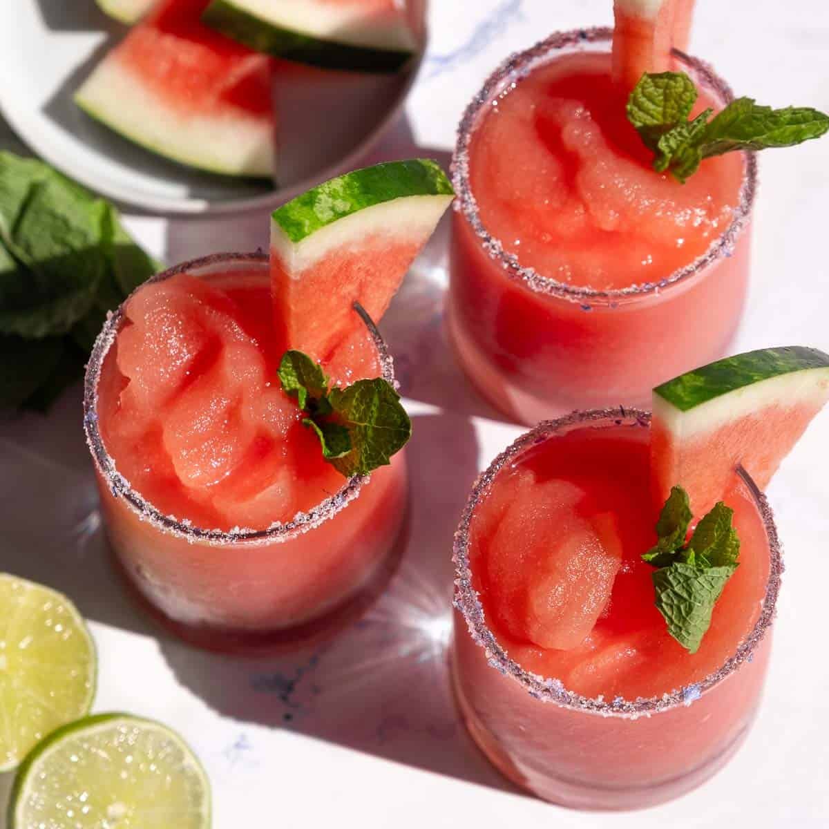 Three glasses filled with Watermelon Frosé Slushies.