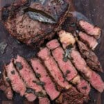 Pinterest image showing sliced rare bison steaks on a cutting board with Vindulge logo.