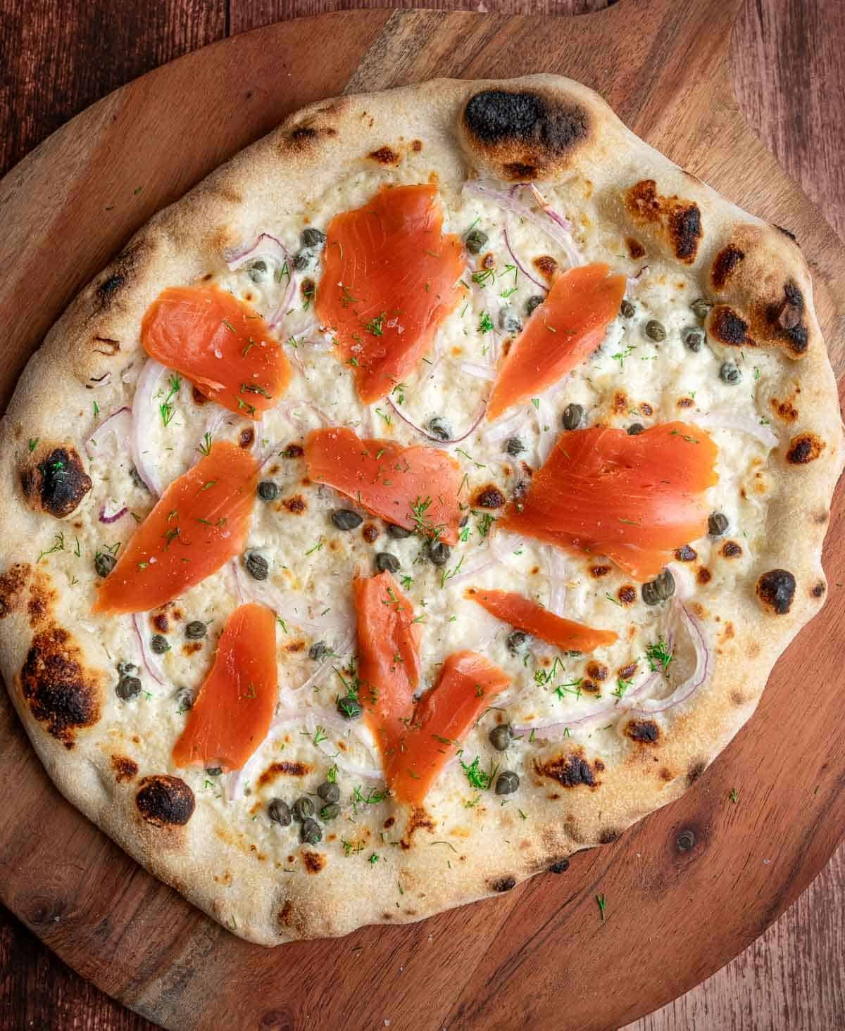 Smoked Salmon Pizza on a cutting board.