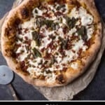A pinterest pin showing an uncut pumpkin fall pizza on parchment paper with a pizza cutter.