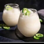 Pinterest pin with two glasses of sauvignon blanc slushie topped with candied jalapeno peppers.