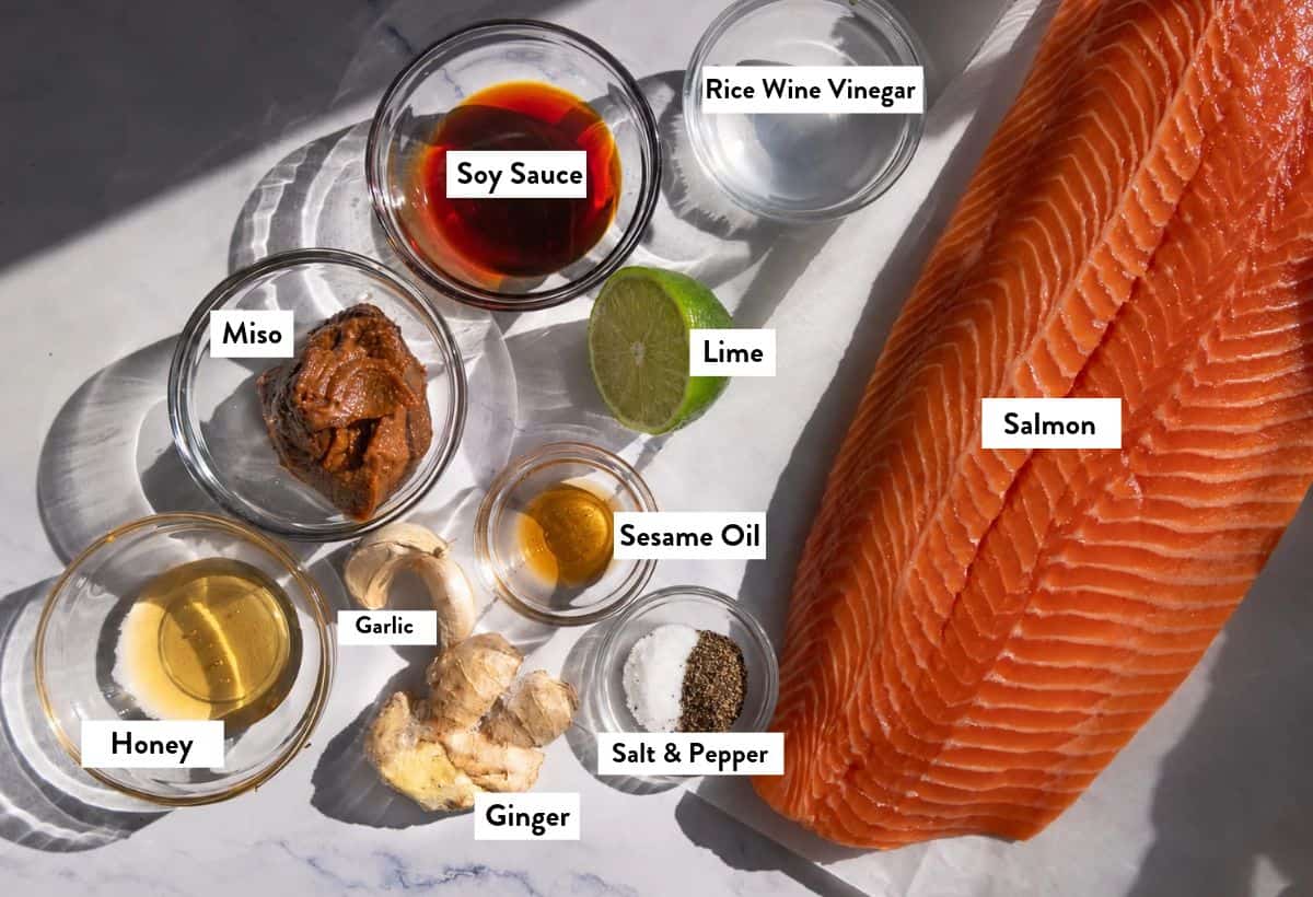 Ingredients for miso glazed salmon on a cutting board, with ingredients labeled.